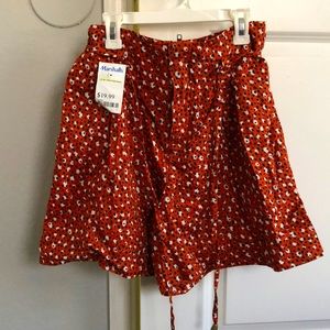 Size 4 shorts, orange with white and black spots